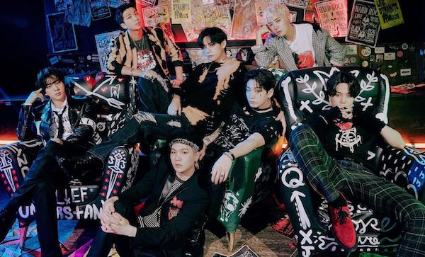 bts members sitting around and posing in grunge streetwear 