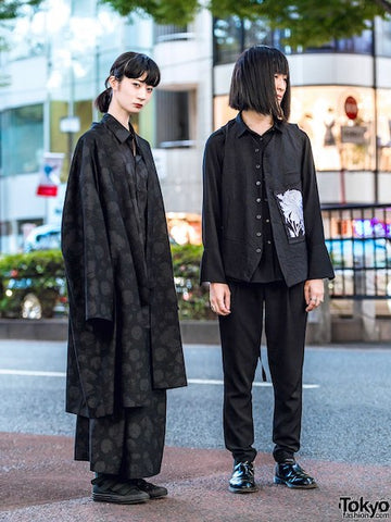 Japanese streetwear minimal monochrome fashion of two fashionably dressed person in black
