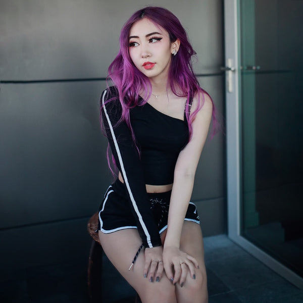 off shoulder crop top and black pants on purple hair model