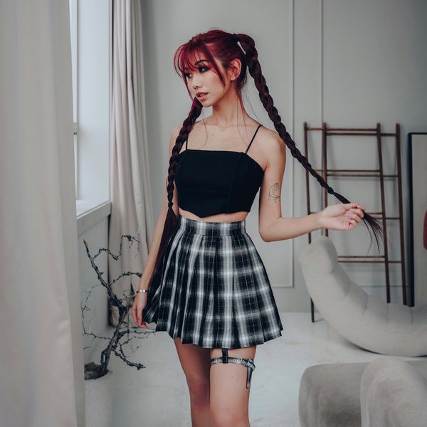 cider leg strap skirt and black crop top on red hair model with two high braids