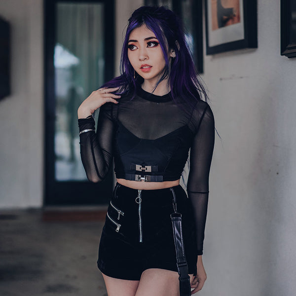 affogato velvet suspender strap shorts with black top and mesh sleeves on purple hair model