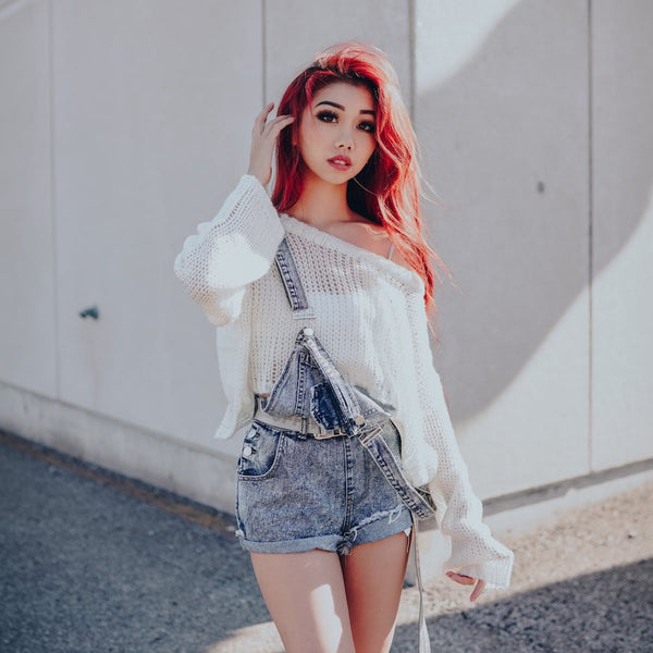 vanilla oversized knitted sweater under overalls that are half on half off on red hair model