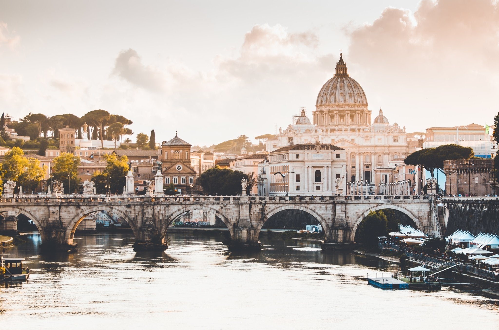 Body of water in front of the Roman buildings with Saint Peter's Basilica Dome in the background