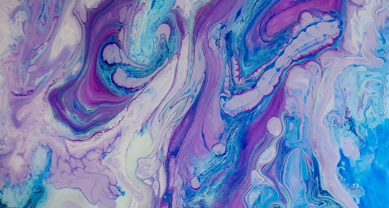 Up close view of the gem opal and its blue, purple, and white swirled colors