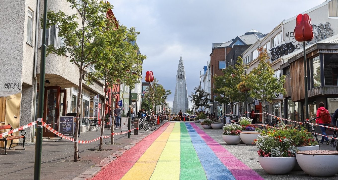 Rainbow road leading to one of Iceland's famous white stone churches