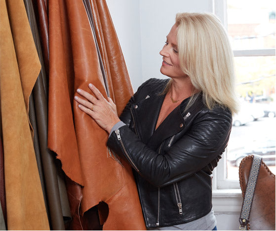 Koren Ray hand seleting leather hides for Hobo bags.