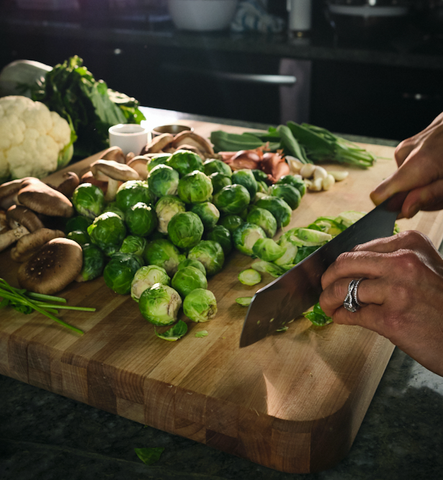 Cutting brussels sprouts on a large boos block cutting board