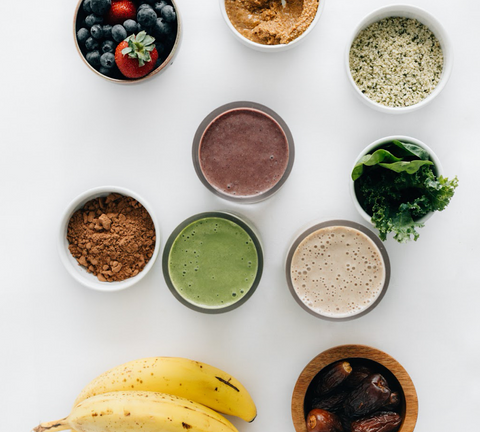 ingredients to make smoothies and 3 prepared smoothies