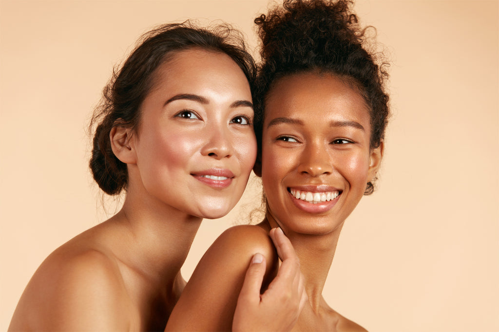 About Glorious Beauty - Two models smiling on a neutral background