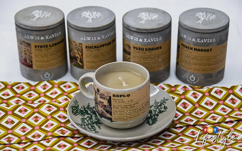 An aromatic coffee-scented candle nestled in a charming cup, emanating warm and inviting vibes by Alwis and Xavier