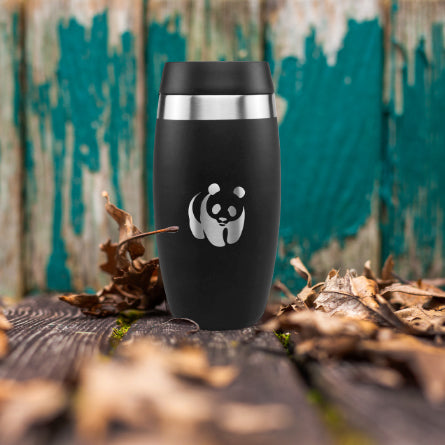 WWF x Ohelo black insulated reusable coffee cup on wooden floor with autumnal leaves