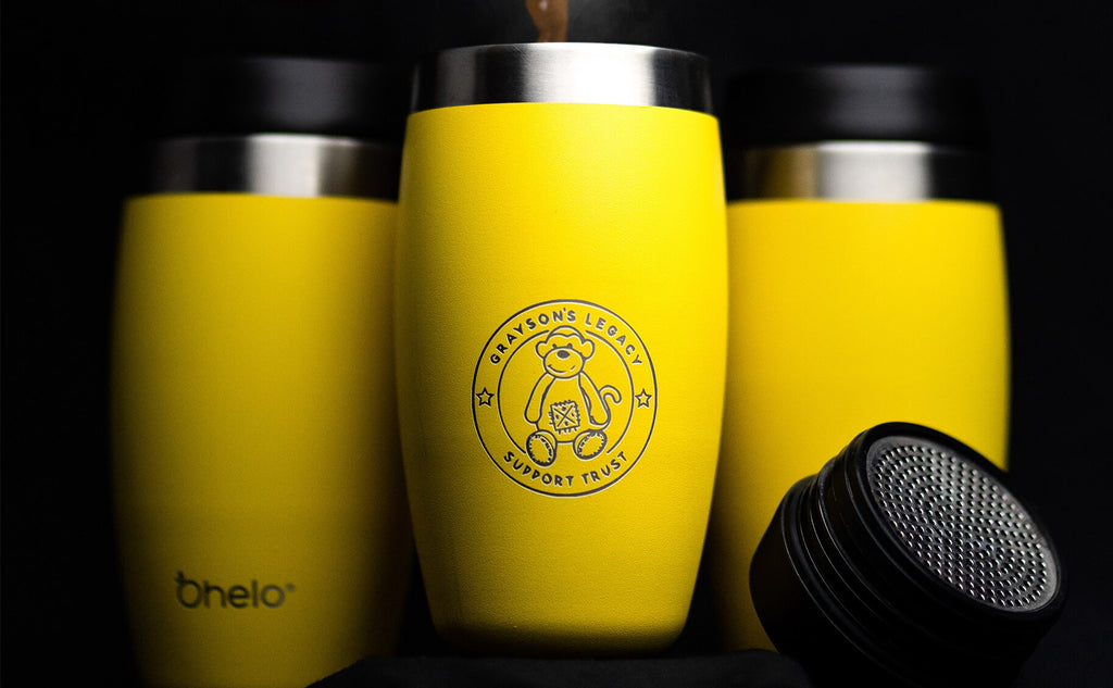 Ohelo yellow tumbler with large teddy logo for co-branding client