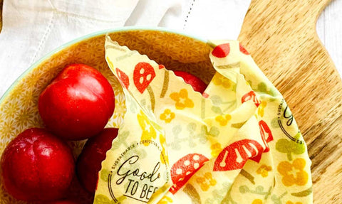Eco-friendly plastic alternatives - beeswax wraps covering food in a wooden bowl