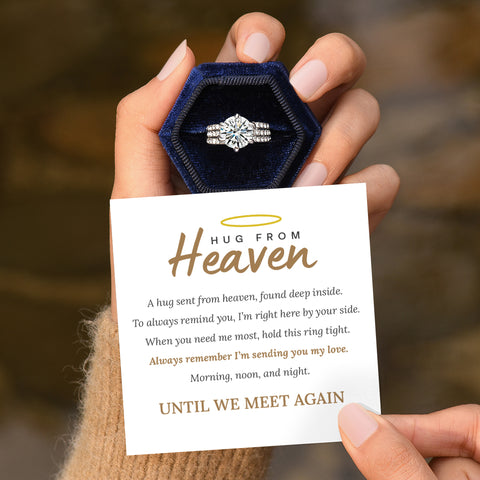 A person holding a message card and a zircon ring in the box