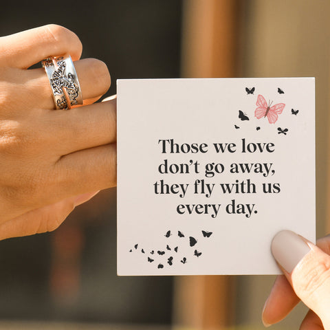 model wearing Personalized Butterfly Memorial Fidget Ring and holding a personalized message card