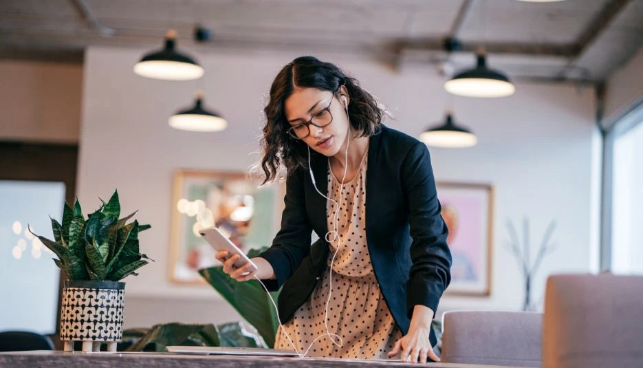 a woman looking at some files while listening from her phone