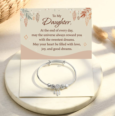 To My Daughter Dreamcatcher Bangle on top of a heartfelt note