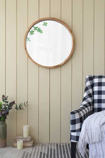 Round mirror with wooden frame decorated on wall grey wall with strips