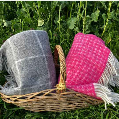 Grey and pink wool blankets in a field