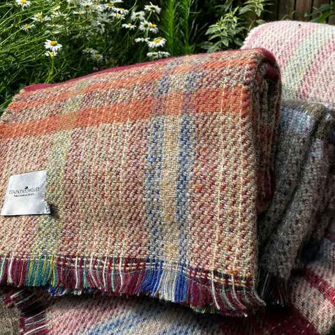 Recycled wool blankets and throws on a bench