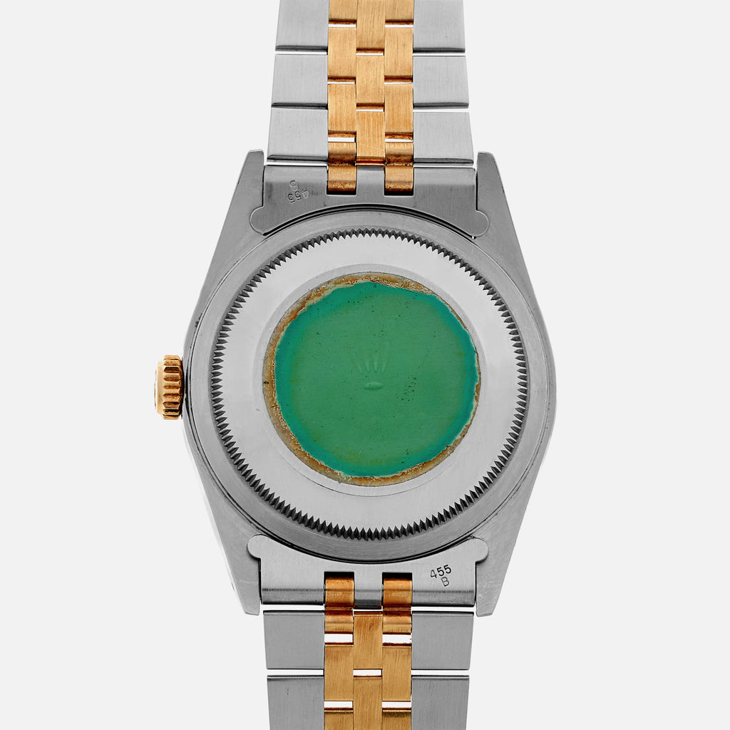 green sticker on back of rolex