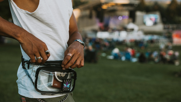Close up of a man wearing Dime Bags clear Party Pack fanny pack at music festival
