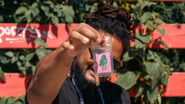 Artist Vincent Gordon holding up Melty Skelty patch