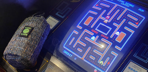 Dime Bags Drawstring Tube resting on vintage Pac-Man game machine