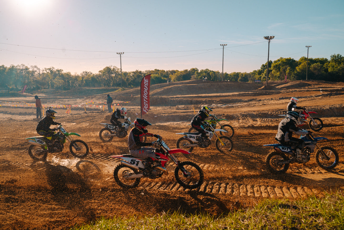 Riders taking off during day in the dirt