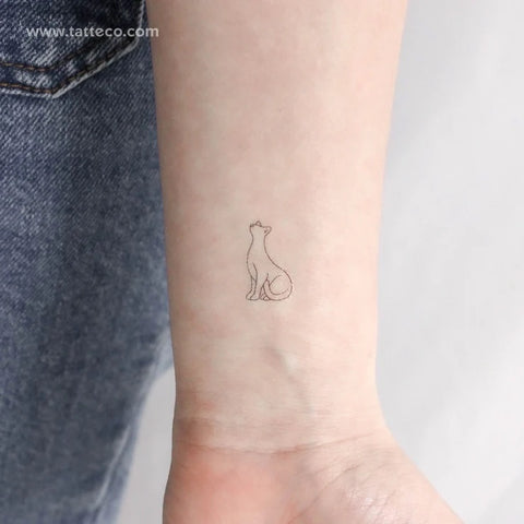 Ancient Egyptian symbol tattoos: A fine line outline of a standing cat tattoo to symbolize the Goddess Bastet