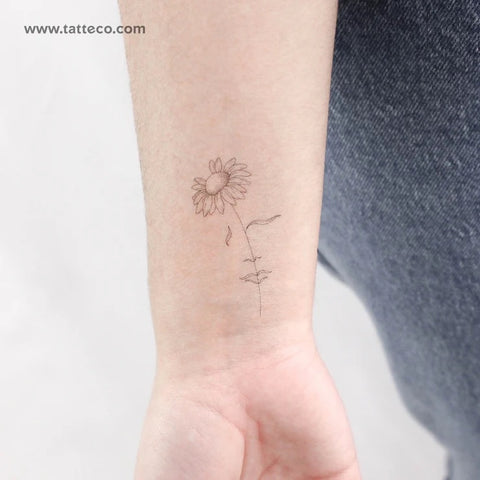 Female figure tattoo: A fine line daisy tattoo with woman's face detail