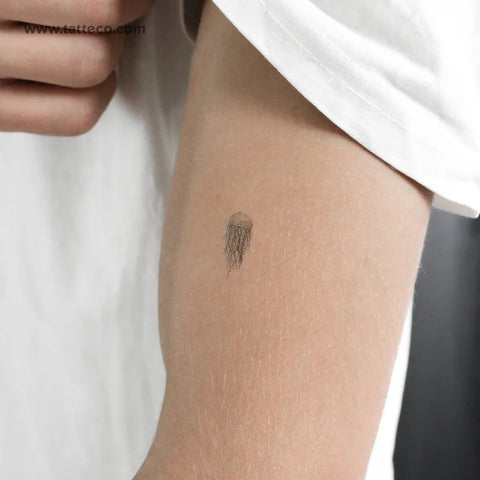Jellyfish tattoos: Small fine line jellyfish tattoo