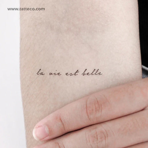 Mantra tattoos: La Vie est Belle, french handwriting quote tattoo