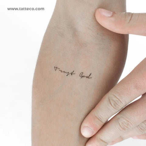 Mantra Tattoos: Trust God, handwritten quote tattoo on arm