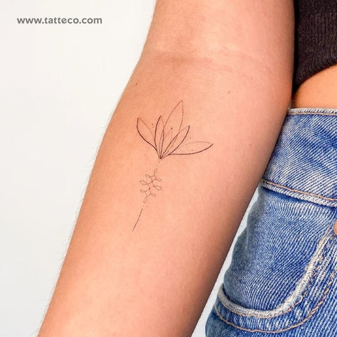 Mindfulness Tattoos: delicate, fine line lotus flower arm tattoo