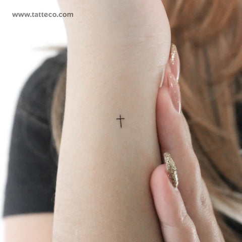 Minimalist Christian Tattoos: Tiny, fine line cross tattoo