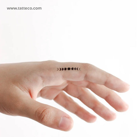 Moon phase tattoo: Black moon phase tattoo on the finger