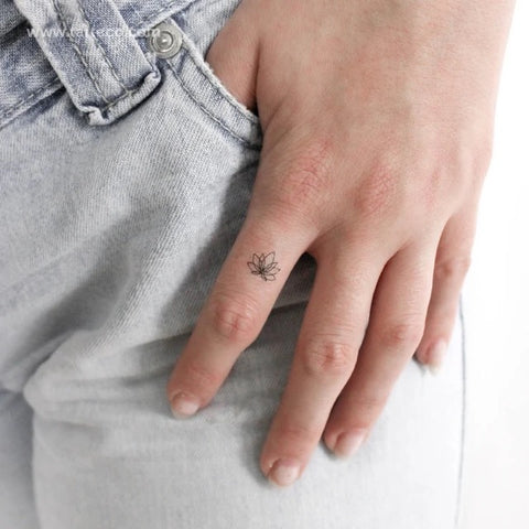 Yoga Tattoos: Minimalist lotus flower tattoo on finger