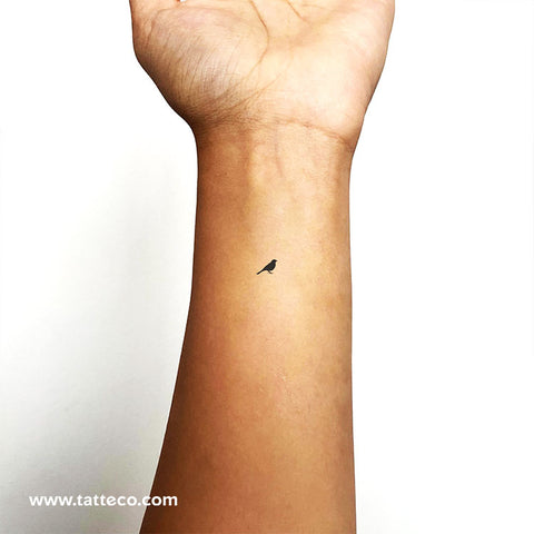 simple bird tattoo on wrist