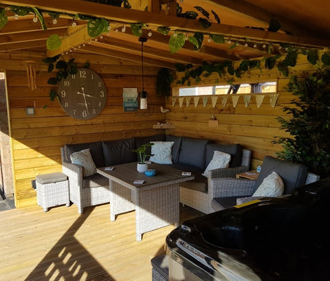 wooden hut with leaf garlands, bunting, rattan furniture and exposed beams 