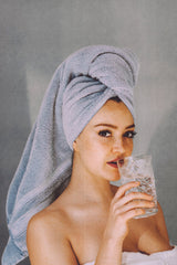 Woman in towel drinking water