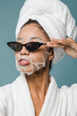 Woman in face mask and bathrobe