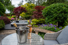 Drinks bucket in front of a hot tub in a garden