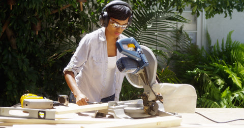 Photo of a girl cutting wood with a table saw