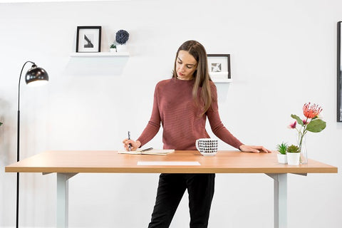 Photo of a woman working for standing desk