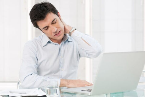 Photo of a businessman holding hand to neck