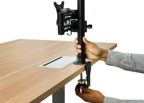 Photo of hands screwing adjustable monitor riser