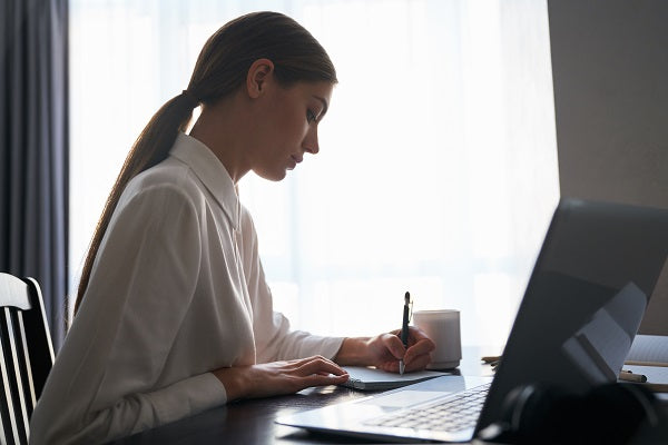 Woman coding on home office computer