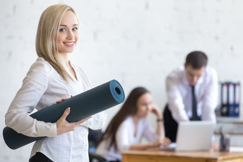 Photo of a happy model posing with an exercise mat and friendly smile at a camera
