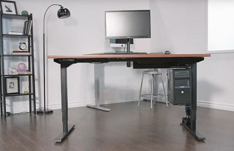 Photo of a standing desk with a computer in a room